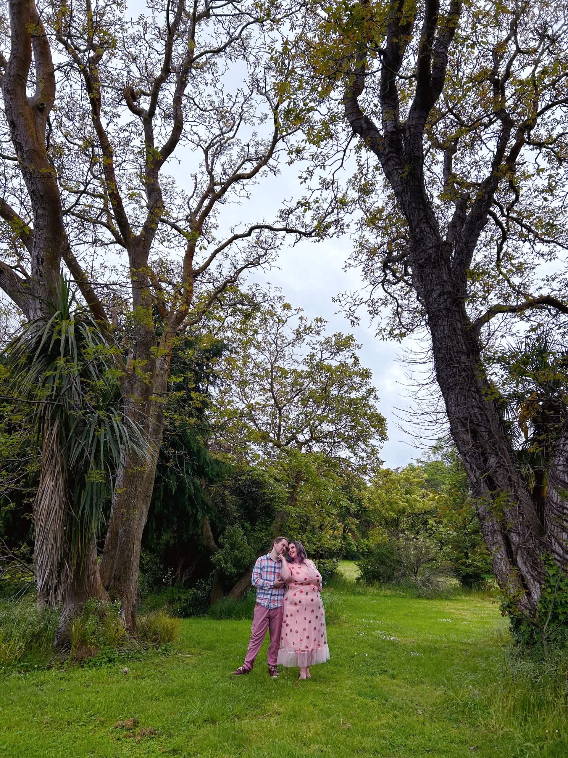 A photo of Alex and Vee in a field.
